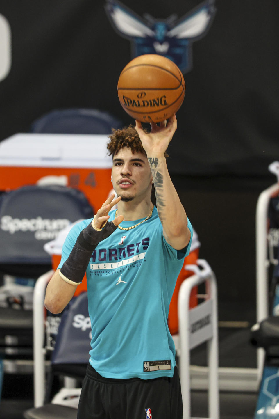 Charlotte Hornets guard LaMelo Ball, wearing a cast on his fractured right wrist, shoots before an NBA basketball game between the Charlotte Hornets and the Atlanta Hawks in Charlotte, N.C., Sunday, April 11, 2021. (AP Photo/Nell Redmond)