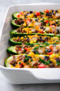 <p>You won't miss the tortilla in these <a href="https://www.delish.com/cooking/g3594/stuffed-zucchini/" rel="nofollow noopener" target="_blank" data-ylk="slk:stuffed zucchinis;elm:context_link;itc:0;sec:content-canvas" class="link ">stuffed zucchinis</a>. They've got everything you love about your favorite <a href="https://www.delish.com/cooking/g2154/burrito-recipes/" rel="nofollow noopener" target="_blank" data-ylk="slk:burrito;elm:context_link;itc:0;sec:content-canvas" class="link ">burrito</a>—<a href="https://www.delish.com/cooking/recipe-ideas/g4252/best-black-bean-recipes/" rel="nofollow noopener" target="_blank" data-ylk="slk:black beans;elm:context_link;itc:0;sec:content-canvas" class="link ">black beans</a>, <a href="https://www.delish.com/cooking/g1463/sweet-corn-recipes/" rel="nofollow noopener" target="_blank" data-ylk="slk:corn;elm:context_link;itc:0;sec:content-canvas" class="link ">corn</a>, <a href="https://www.delish.com/cooking/recipe-ideas/g41505454/cheese-recipes/" rel="nofollow noopener" target="_blank" data-ylk="slk:CHEESE;elm:context_link;itc:0;sec:content-canvas" class="link ">CHEESE</a>—minus the carbs!</p><p>Get the<strong> <a href="https://www.delish.com/cooking/recipe-ideas/a19757076/burrito-zucchini-boats-recipe/" rel="nofollow noopener" target="_blank" data-ylk="slk:Zucchini Burrito Boats recipe;elm:context_link;itc:0;sec:content-canvas" class="link ">Zucchini Burrito Boats recipe</a></strong>.</p>