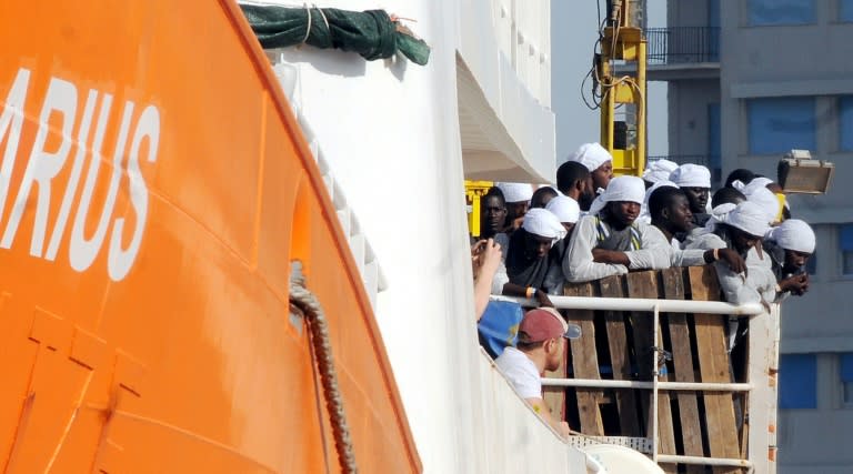 Migrants and refugees arrive at the Trapani port on the Aquarius vessel on July 22, 2016 after being rescued at sea