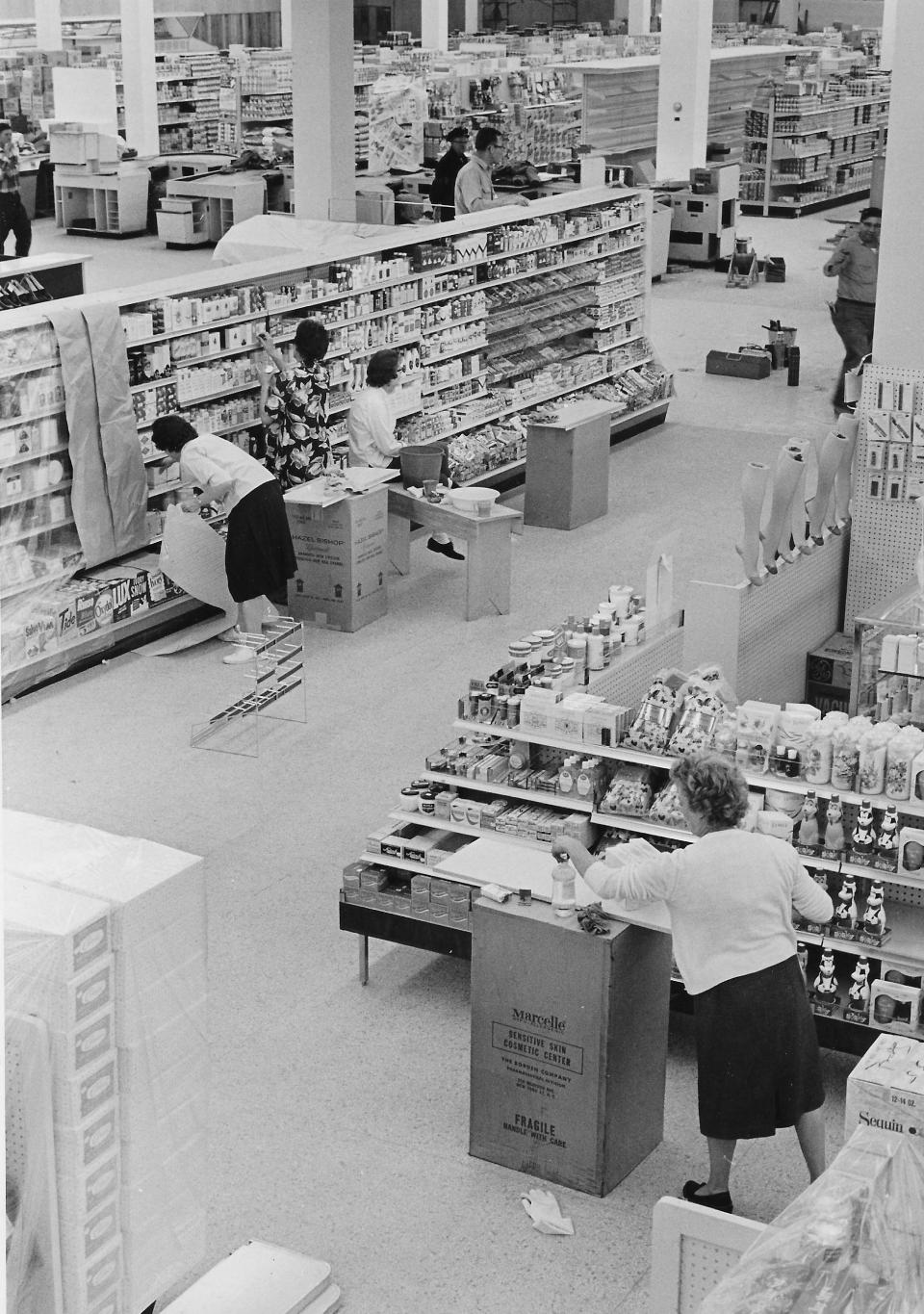 Employees stock the shelves of Five Points Shopping Center on Nov. 8, 1962. Peoples Drugs is in the foreground with Acme in the back.