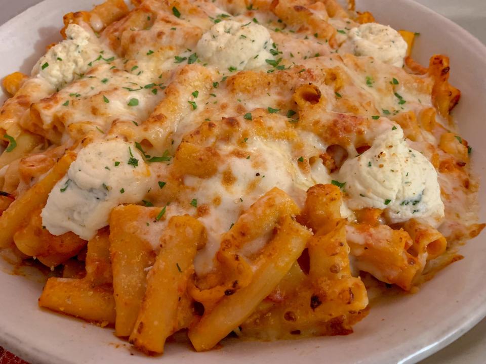 Baked ziti with ricotta in a white bowl.