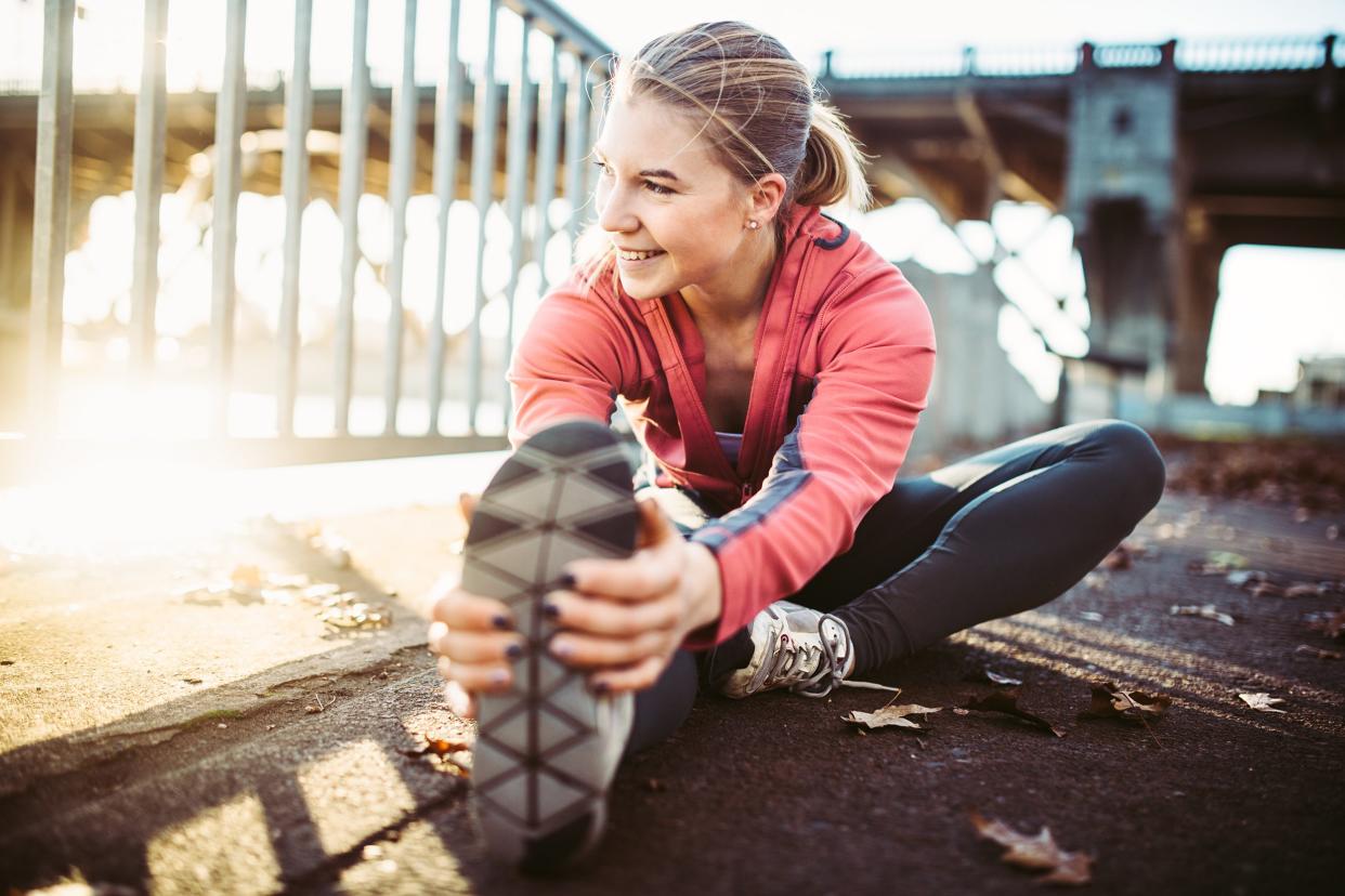 woman stretching before a run