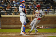 New York Mets catcher Tomas Nido looks to the infield as St. Louis Cardinals' Tyler O'Neill, right, scores on a sacrifice fly by Dylan Carlson during the fourth inning of a baseball game Tuesday, Sept. 14, 2021, in New York. (AP Photo/Frank Franklin II)