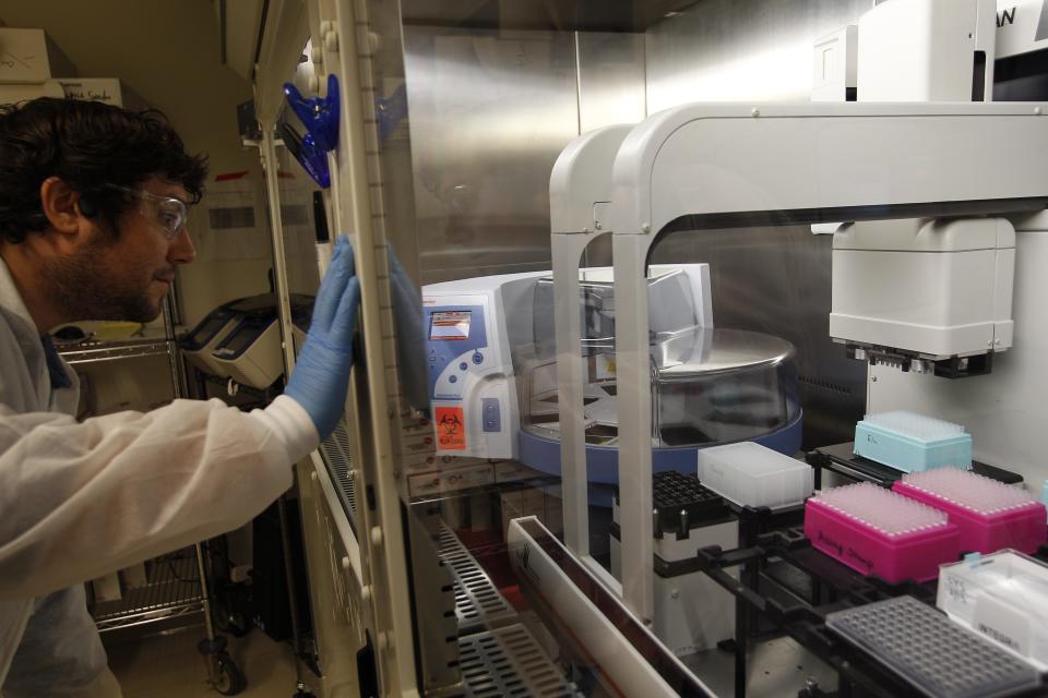 ASU senior engineer Ian Shoemaker monitors machines they plan to use to rapidly process hundreds of tests for the new coronavirus.