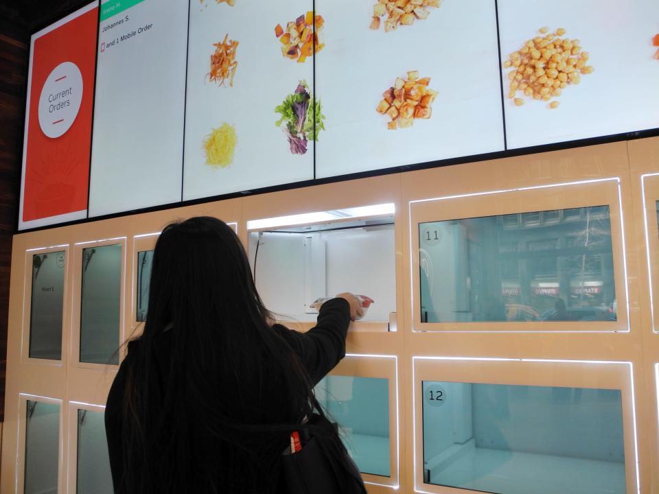 A client picks up her order at a branch of the robot restaurant Eatsa in New York, US, 2 March 2017.