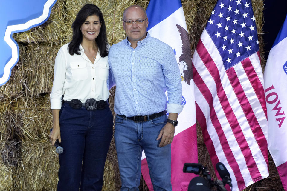 FILE - Republican presidential candidate and former U.N. Ambassador Nikki Haley stands on stage with her husband Michael during U.S. Sen. Joni Ernst's Roast and Ride, Saturday, June 3, 2023, in Des Moines, Iowa. Nikki Haley’s husband will soon begin a yearlong deployment with the South Carolina Army National Guard to Africa, a mission that will encompass most of the remainder of his wife’s campaign for the 2024 Republican presidential nomination. (AP Photo/Charlie Neibergall, File)