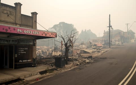 The rubble of buildings sits on the ground after they were destroyed by fire in Cobargo, New South Wales - Credit: Rex