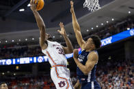 Auburn guard Devan Cambridge (35) goes for a layup over Yale forward Isaiah Kelly (35) during the first half of an NCAA college basketball game, Saturday, Dec. 4, 2021, in Auburn, Ala. (AP Photo/Vasha Hunt)