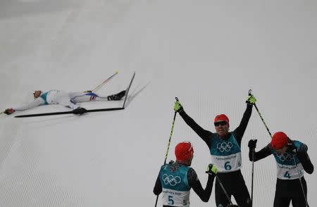 Nordic Combined Events - Pyeongchang 2018 Winter Olympics - Men's Individual 10 km Final - Alpensia Cross-Country Skiing Centre - Pyeongchang, South Korea - February 20, 2018 - Gold medalist, Johannes Rydzek of Germany, silver medalist, Fabian Riessle of Germany and bronze medalist Eric Frenzel of Germany celebrate as Jarl Magnus Riiber of Norway reacts. REUTERS/Carlos Barria