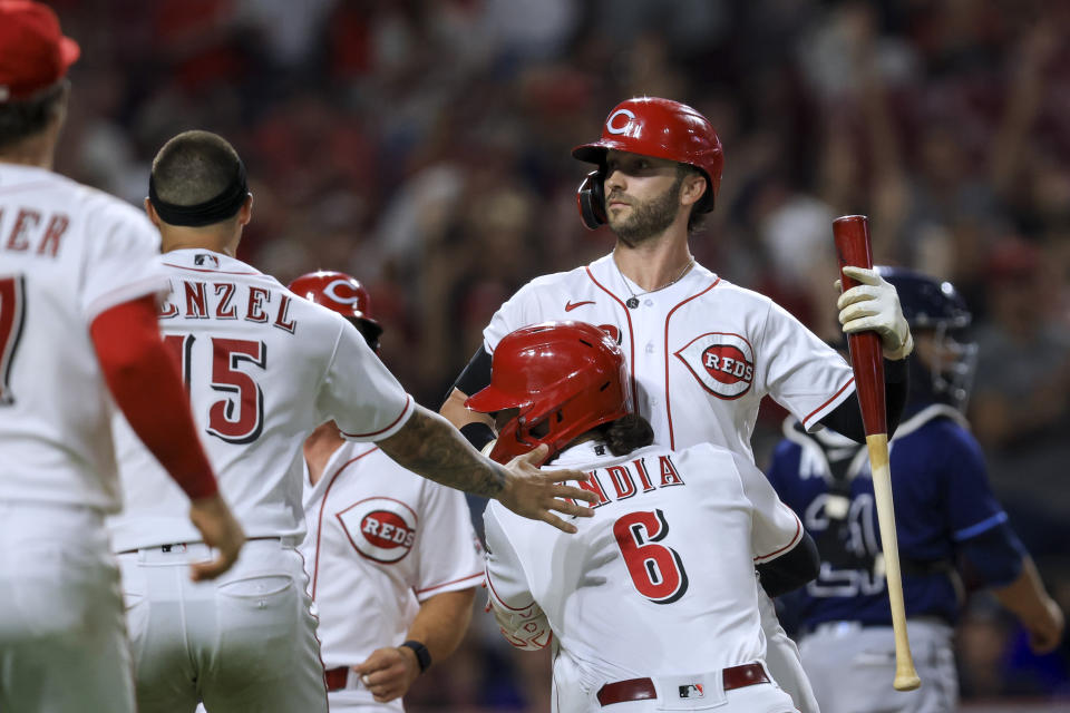 Cincinnati Reds' Tyler Naquin celebrates with teammates, including Jonathan India, after a balk by Tampa Bay Rays' Jason Adam scored the winning run during the 10th inning of a baseball game in Cincinnati, Friday, July 8, 2022. The Reds won 2-1. (AP Photo/Aaron Doster)