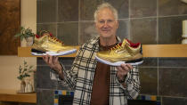 This photo provided by the Portland Rescue Mission shows Nike design legend Tinker Hatfield as he authenticates a pair of of gold Nike Air Jordan 3 sneakers that were dropped at a donation chute at the Portland Rescue Mission on Oct. 31, 2023 in Portland, Ore. A pair of rare Nike sneakers donated to a homeless shelter in Portland, Oregon, are up for auction and are expected to raise as much as $20,000. Why? They were custom-made for filmmaker Spike Lee. (Aaron Ankrom/Portland Rescue Mission via AP)