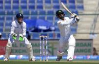 Cricket - Pakistan v England - First Test - Zayed Cricket Stadium, Abu Dhabi, United Arab Emirates - 13/10/15 Pakistan's Mohammad Hafeez (R) in action as England's Jos Buttler looks on Action Images via Reuters / Jason O'Brien Livepic