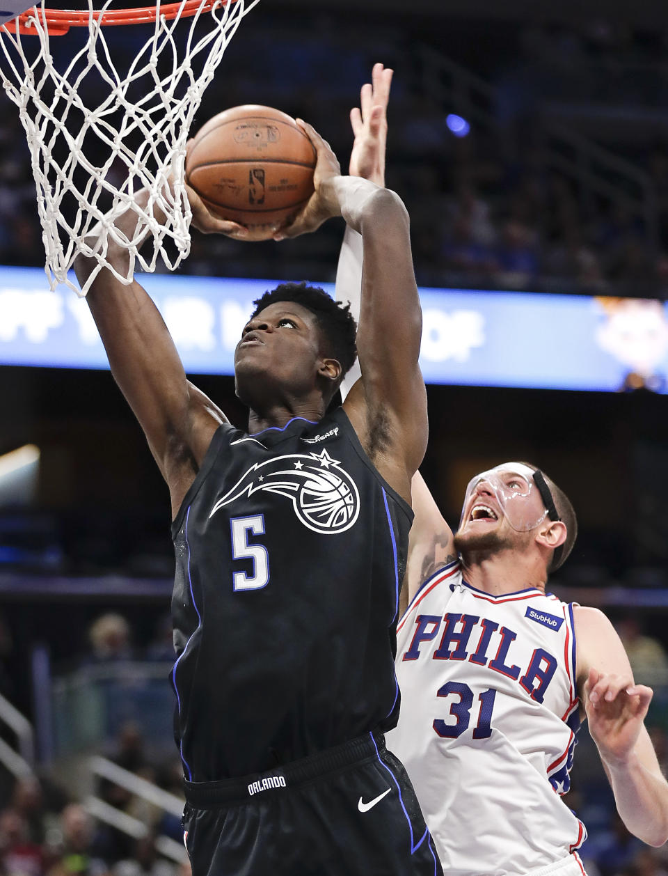 Orlando Magic's Mo Bamba (5) goes up for a dunk past Philadelphia 76ers' Mike Muscala (31) during the second half of an NBA basketball game Wednesday, Nov. 14, 2018, in Orlando, Fla. (AP Photo/John Raoux)