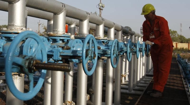 A technician opens a pressure gas valve inside the Oil and Natural Gas Corp (ONGC) group gathering station on the outskirts of Ahmedabad March 2, 2012. REUTERS/Amit Dave/Files