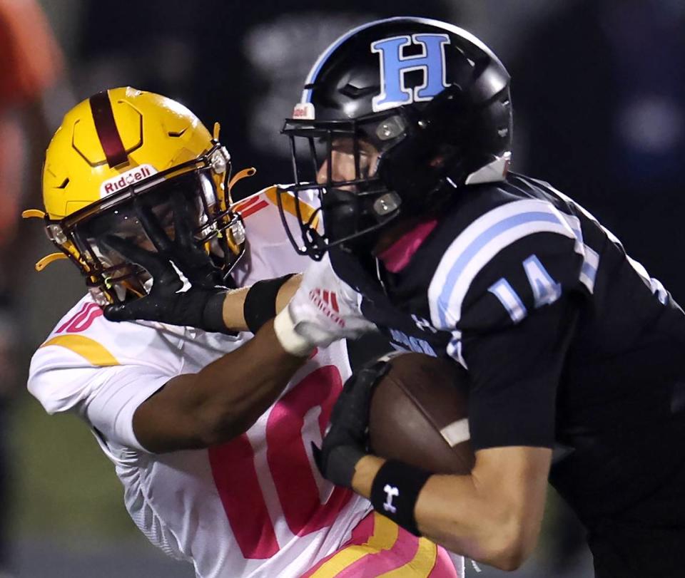 West Charlotte’s Demetrius Rivers, left, gets a face full of Hough Huskies wide receiver Ashton Hampton’s right hand following a pass reception during action on Friday, October 6, 2023.