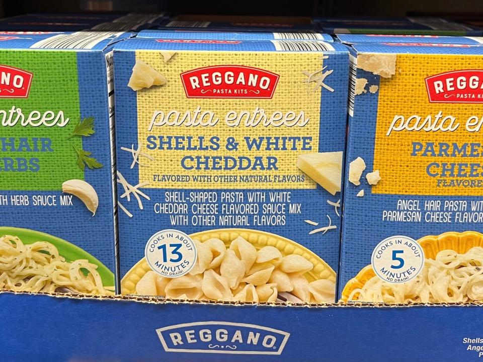 Blue boxes of Reggano pasta entrées with images of plates of pasta on the boxes