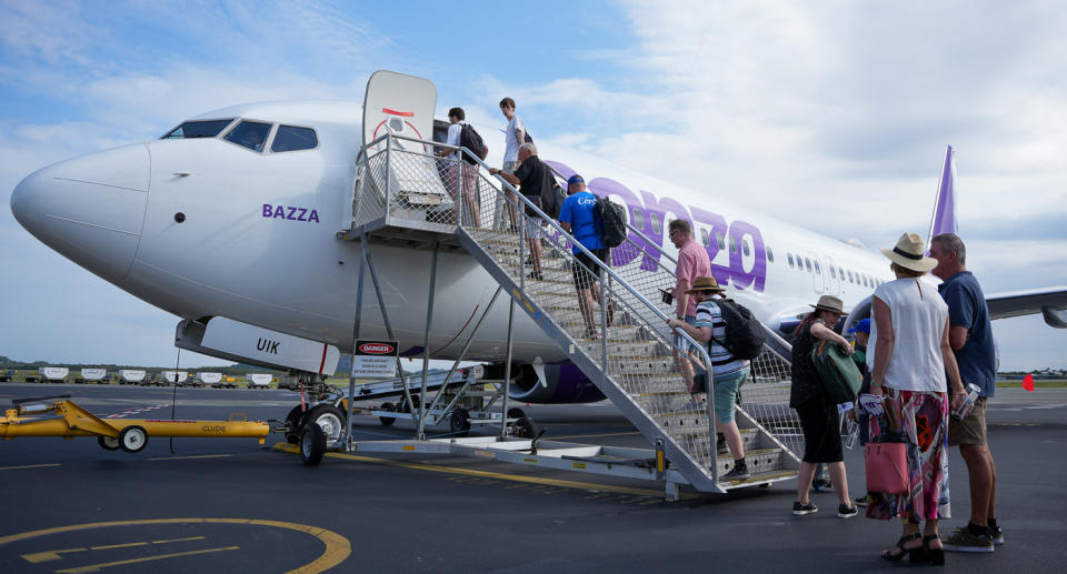 Bonza airlines with passengers boarding a plane