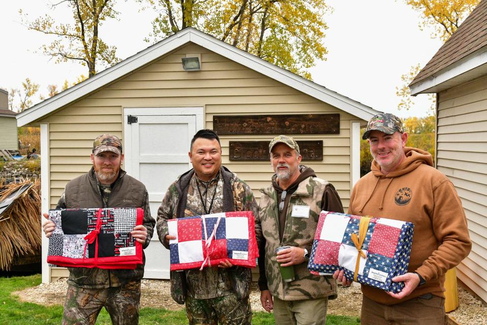 Event organizer Andy Johnson, second from right, stands with three military veterans at the 2023 Horicon Marsh Veterans Hunt who won quilts donated by Jayne Herling of Fountain Hills, Arizona.