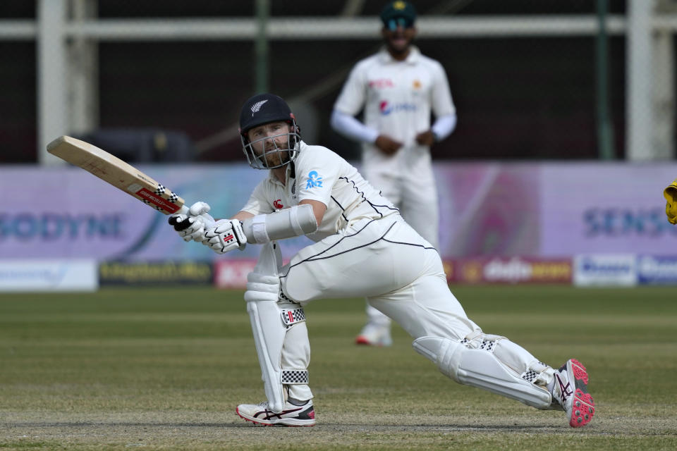 New Zealand's Kane Williamson follows the ball after playing a shot as Pakistan's Sarfraz Ahmed watches during the fourth day of first test cricket match between Pakistan and New Zealand, in Karachi, Pakistan, Thursday, Dec. 29, 2022. (AP Photo/Fareed Khan)