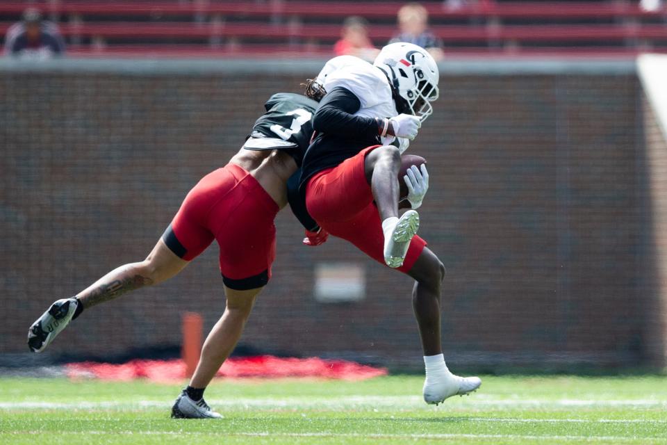 Cincinnati Bearcats linebacker Deshawn Pace takes down Cincinnati Bearcats wide receiver Dee Wiggins (2) during the Cincinnati Bearcats spring scrimmage at Nippert Stadium on Saturday, April 15, 2023.