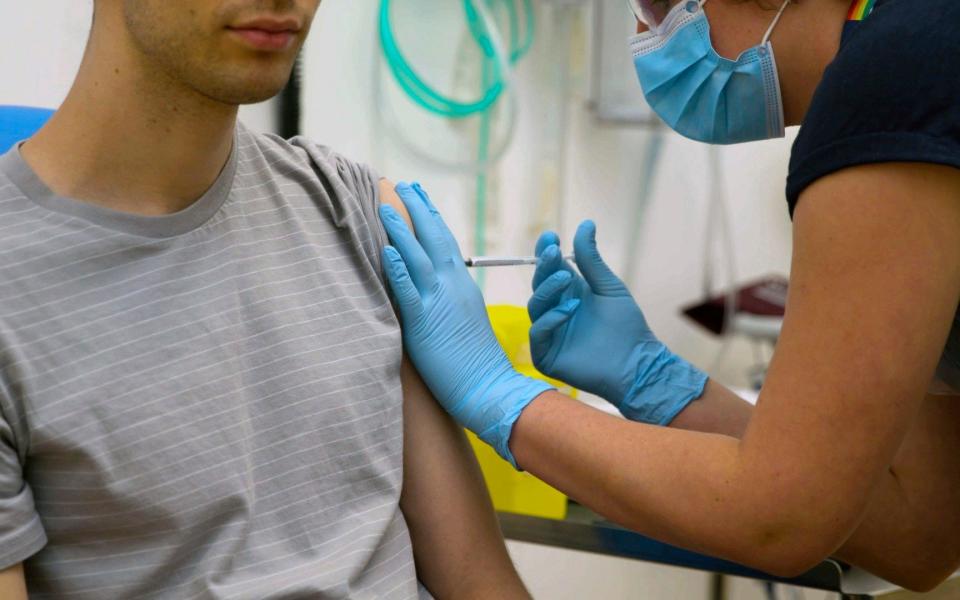 A volunteer is injected with either an experimental COVID-19 vaccine or a comparison shot as part of the first human trials in the U.K. to test a potential vaccine, led by Oxford University - Oxford University/Oxford University