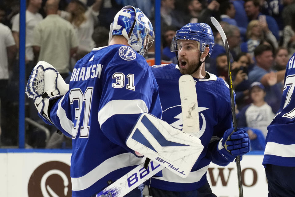 Tampa Bay Lightning goaltender Jonas Johansson (31) celebrates with defenseman Calvin de Haan (44) after the team defeated the Edmonton Oilers during an NHL hockey game Saturday, Nov. 18, 2023, in Tampa, Fla. (AP Photo/Chris O'Meara)