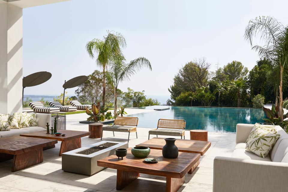 On the terrace, the sofa is from Andreu World, the coffee and side tables by Il Giardino di Legno. The chairs and sunbeds are Meridiani with Nobilis Bondi fabric. Cushions are Jim Thompson Belize fabric, and the sun umbrellas are Paola Lenti.