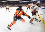 Anaheim Ducks' Ryan Getzlaf (15) and Edmonton Oilers' Connor McDavid (97) compete for the puck during the second period of an NHL hockey game Tuesday, Oct. 19, 2021, in Edmonton, Alberta. (Jason Franson/The Canadian Press via AP)