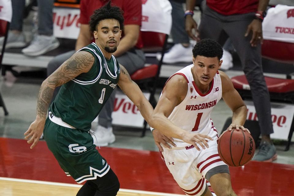 Wisconsin's Jonathan Davis drives past Wisconsin-Green Bay's Josh Jefferson during the second half of an NCAA college basketball game Tuesday, Dec. 1, 2020, in Madison, Wis. (AP Photo/Morry Gash)
