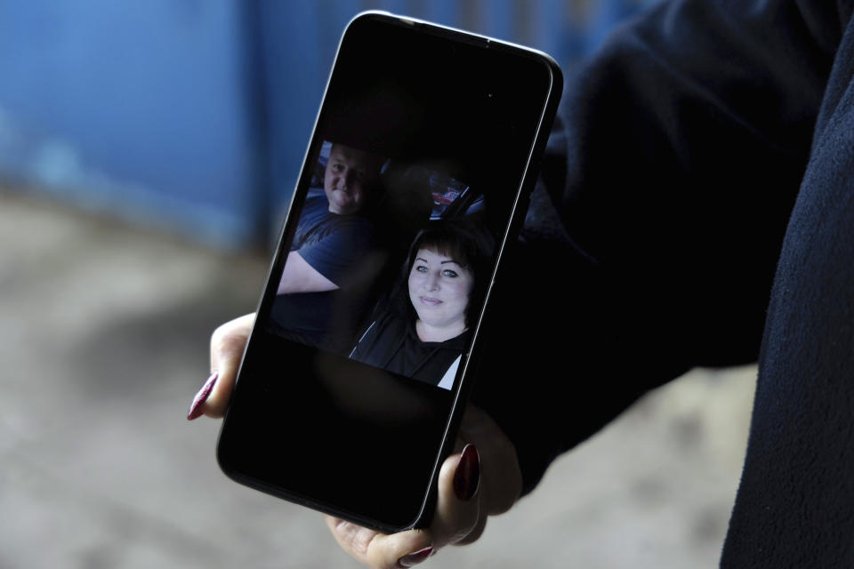 A picture of Anatolii Panteleiev, 42 and his wife Olha Panteleieva, 36 is seen on the smartphone screen in the village of Hroza near Kharkiv, Ukraine, Friday, Oct. 6, 2023. Anatolii and Olha are victims of a Russian rocket hit, which killed at least 51 civilians. (AP Photo/Alex Babenko)