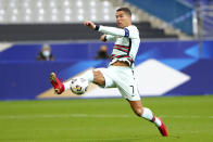 FILE - In this Sunday, Oct. 11, 2020 file photo Portugal's Cristiano Ronaldo stretches for the ball during the UEFA Nations League soccer match between France and Portugal at the Stade de France in Saint-Denis, north of Paris, France. The Portuguese soccer federation says Cristiano Ronaldo has tested positive for the coronavirus. The federation says Ronaldo is doing well and has no symptoms. He has been dropped from the country's Nations League match against Sweden on Wednesday. (AP Photo/Thibault Camus, File)