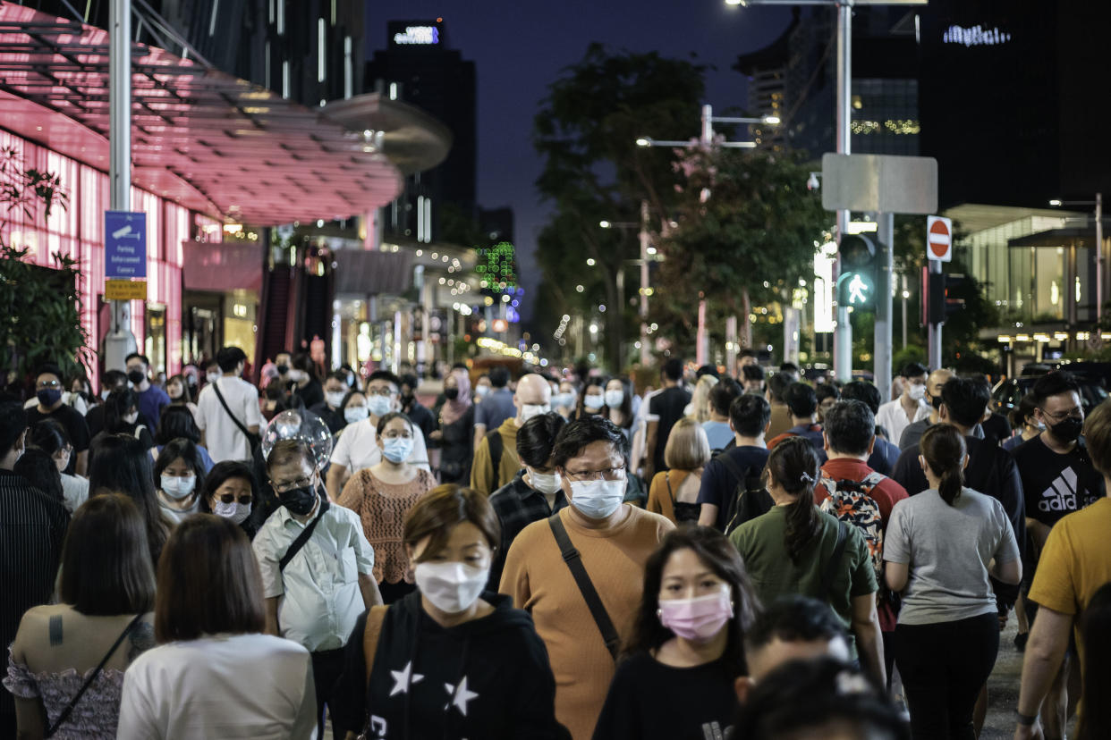 People wearing face masks long Orchard Road. 