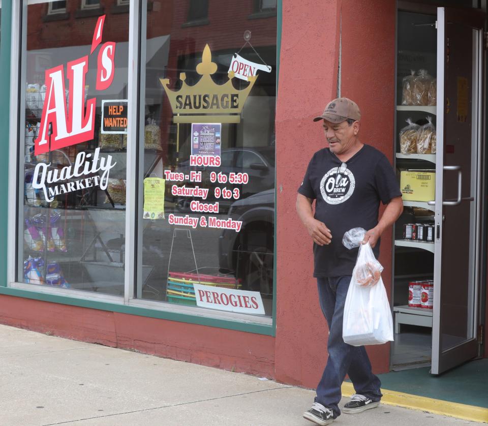 A customer leaves Al's Quality Market on Wednesday, August 16, 2023 in Barberton, Ohio. The Market has been a fixture in Barberton for 75 years.