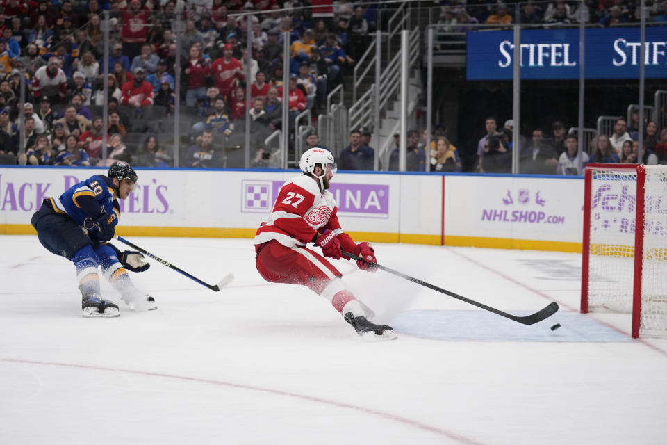 Detroit Red Wings' Michael Rasmussen (27) scores an empty-net goal as St. Louis Blues' Brayden Schenn (10) watches during the third period of an NHL hockey game Tuesday, Dec. 12, 2023, in St. Louis. (AP Photo/Jeff Roberson)