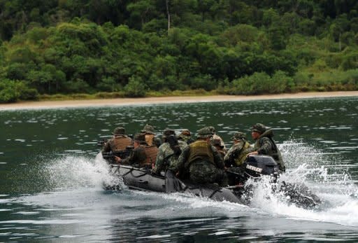 Philippine and US marines speed towards the shore of Tagcauayan beach during a beach raid simulation as part of their joint military exercise in Puerto Princesa, Palawan island, on April 23. The Philippines, lamenting the poor state of its armed forces, appealed Monday for US and international help in building a "minimum credible defense" amid an escalating territorial dispute with China