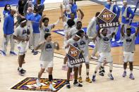 Memphis players and staff celebrate their win against Mississippi State in an NCAA college basketball championship game in the NIT, Sunday, March 28, 2021, in Frisco, Texas. (AP Photo/Tony Gutierrez)