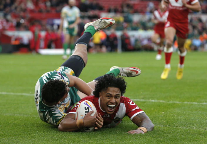 Tonga's Tesi Niu goes over the line to score a try during the Rugby League World Cup group D match between Tongo and Cook Islands at the Riverside Stadium in Middlesbrough, England, Sunday Oct. 30, 2022. (Will Matthews/PA via AP)
