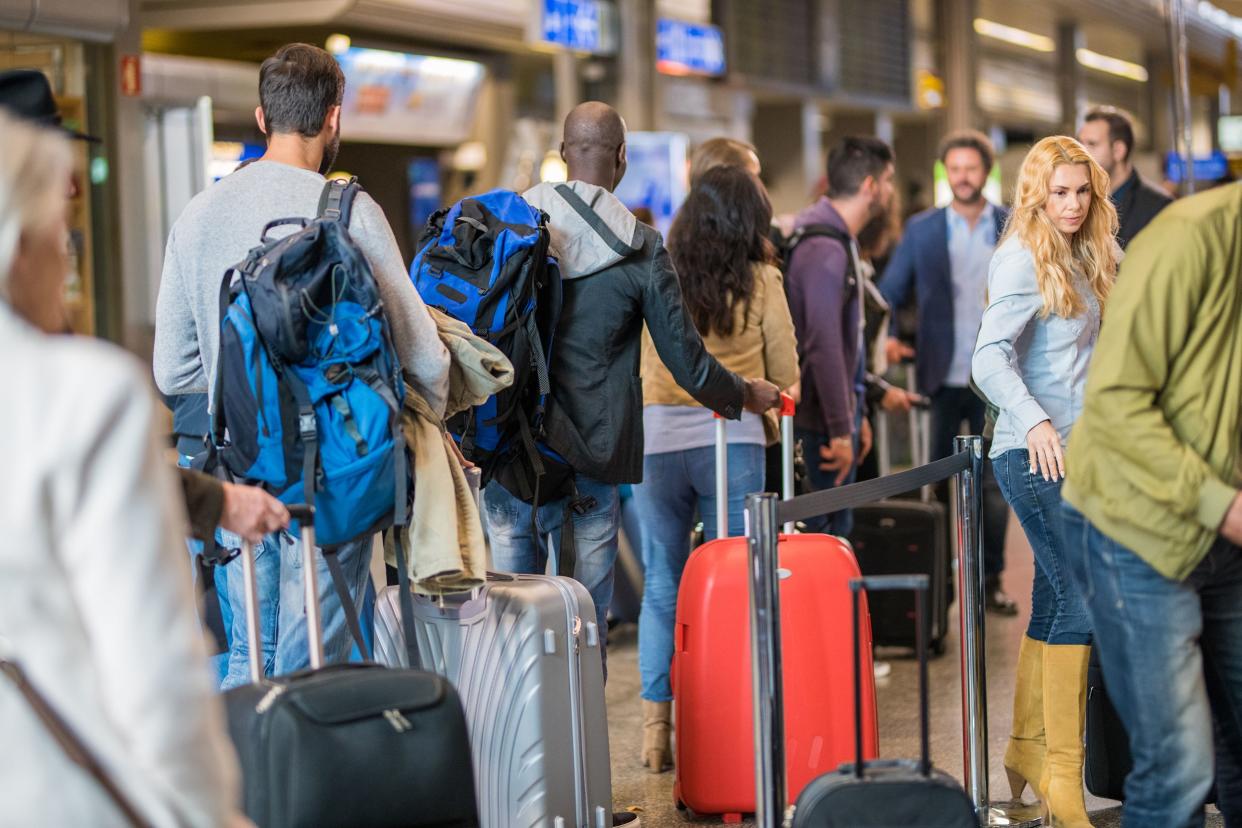 people standing in queue at airport