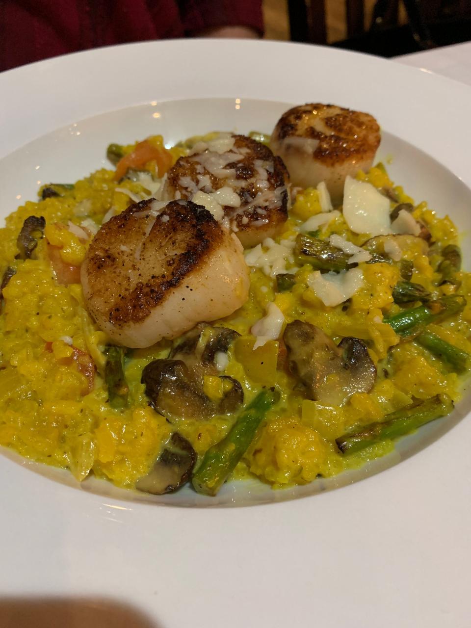 The Chowder House's scallop risotto features jumbo scallops over lobster stock-infused risotto, which gets its yellow color from turmeric.