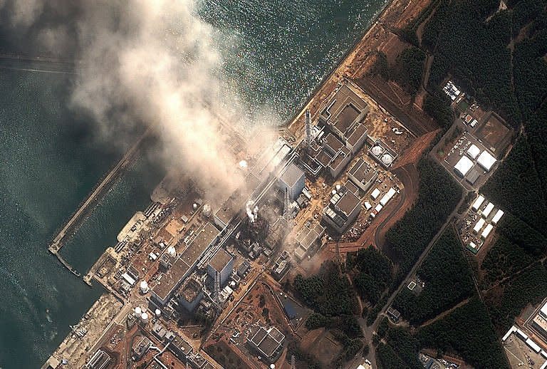 This DigitalGlobe handout image shows the earthquake and tsunami damaged Fukushima Daiichi nuclear plant. The container around an overheating nuclear reactor appears to be damaged, Japan's government said Tuesday, raising the chance that dangerous radiation could leak from the quake-hit plant