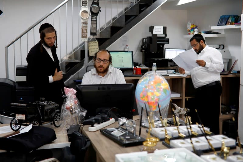 FILE PHOTO: David Hamburger, 36, an ultra-Orthodox Jewish man, works in his shop in the Israeli settlement of Beitar Illit in the occupied West Bank