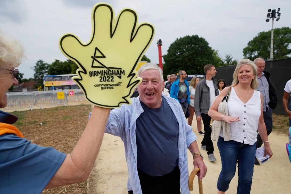 A man gives a high five to a volunteer (AP)