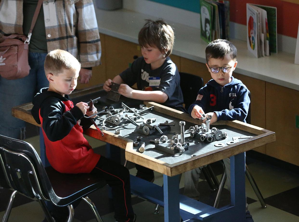 Kids work on metal parts and shapes as they visit the Children's Museum of New Hampshire in Dover Nov. 15, 2023.