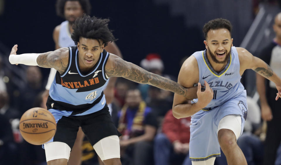 Cleveland Cavaliers' Kevin Porter Jr. (4) and Memphis Grizzlies' Kyle Anderson (1) battle for the ball in the first half of an NBA basketball game, Friday, Dec. 20, 2019, in Cleveland. (AP Photo/Tony Dejak)