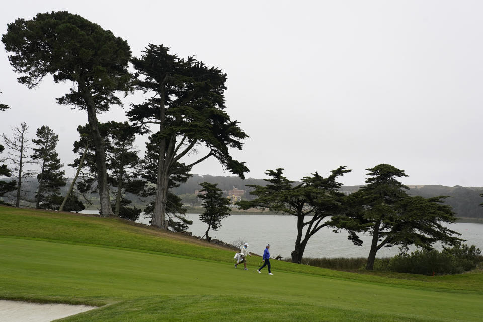 Davis Love III, right, walks on the 15th fairway during practice for the PGA Championship golf tournament at TPC Harding Park in San Francisco, Tuesday, Aug. 4, 2020. (AP Photo/Jeff Chiu)