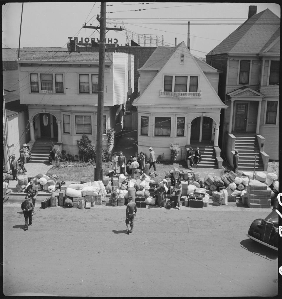 Japanaese americans removing their belongings from their homes prior to mandatory internment