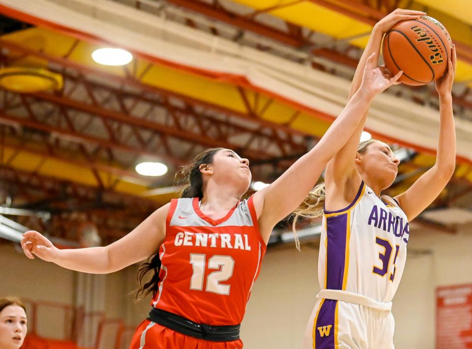 Watertown's Kendall Paulson (35) grabs a rebound beyond the reach of Rapid City Central's Leah Landry (12) during a game on Saturday, Jan. 21, 2023  in Naasz Gymnasium.