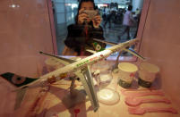 A passenger takes pictures of Eva Airlines' Hello Kitty-themed products displayed in Taoyuan International Airport, northern Taiwan, April 30, 2012. Taiwan's second-largest carrier, Eva Airlines, and Japan's comic company, Sanrio, which owns the Hello Kitty brand, collaborated on the second generation Hello Kitty-themed aircraft which was launched on October 2011. There are currently three Hello Kitty-themed Airbus A330-300 aircrafts flying between cities such as Taipei, Fukuoka, Narita, Sapporo, Incheon, Hong Kong and Guam. REUTERS/Pichi Chuang