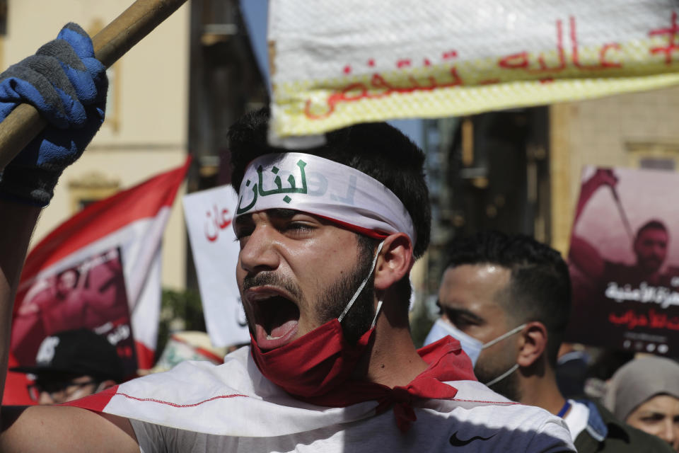 An anti-government protester shouts slogans against the government in Beirut, Lebanon, Saturday, June 13, 2020. Lebanese protesters took to the streets in Beirut and other cities in mostly peaceful gatherings against the government, calling for its resignation as the small country sinks deeper into economic distress. (AP Photo/Hassan Ammar)