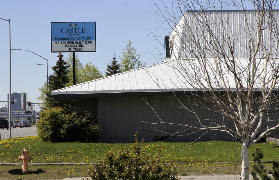 This May 24, 2021, shows a sex store across the street from the Open Door Baptist Church , located inside a former strip club in Anchorage, Alaska. Pastor Kenny Menendez hopes that the church — which is also situated between a marijuana retail store and downtrodden motels — could be a start to improving the neighborhood. (AP Photo/Mark Thiessen)